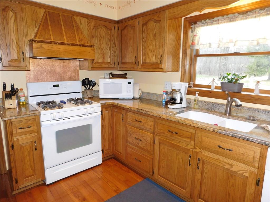 105 Spohn Road Freeport, PA 16229 - Photo 9 of 25 The heart of it all!!! The kitchen's warm, inviting oak cabinetry, stunning granite counter tops, copper accent back splash and wide window make food preparation pleasurable.