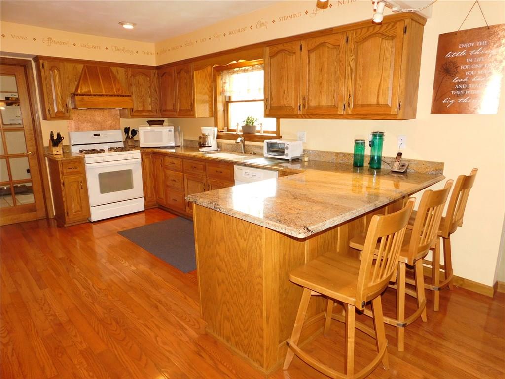 105 Spohn Road Freeport, PA 16229 - Photo 10 of 25 Three seat breakfast bar also serves as a buffet serving area. Glowing, easy to care for oak hardwood flooring tops it off.