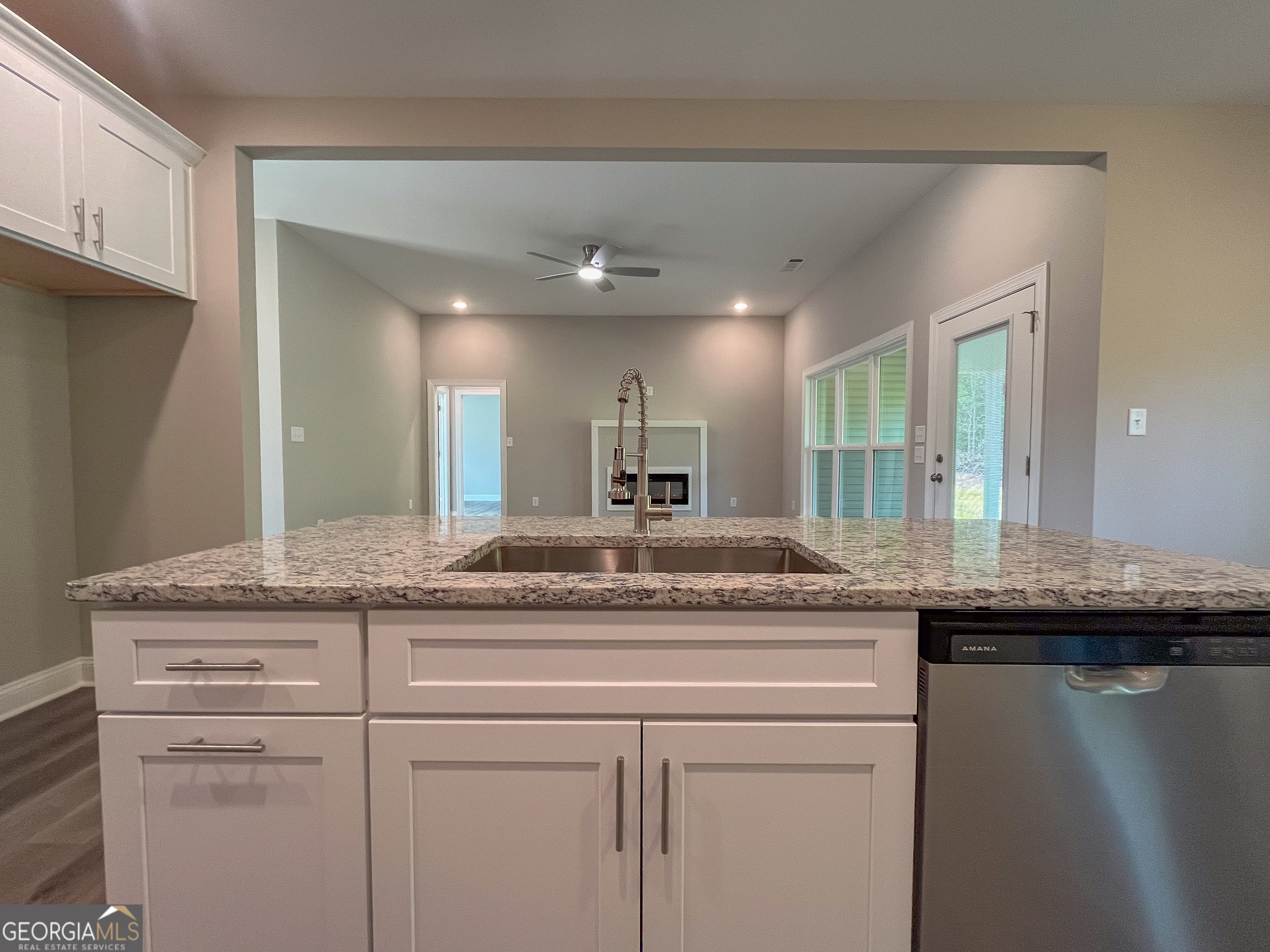 711 Flanders Lane Dublin, GA 31021 - Photo 11 of 49 a kitchen with stainless steel appliances granite countertop a sink and a refrigerator