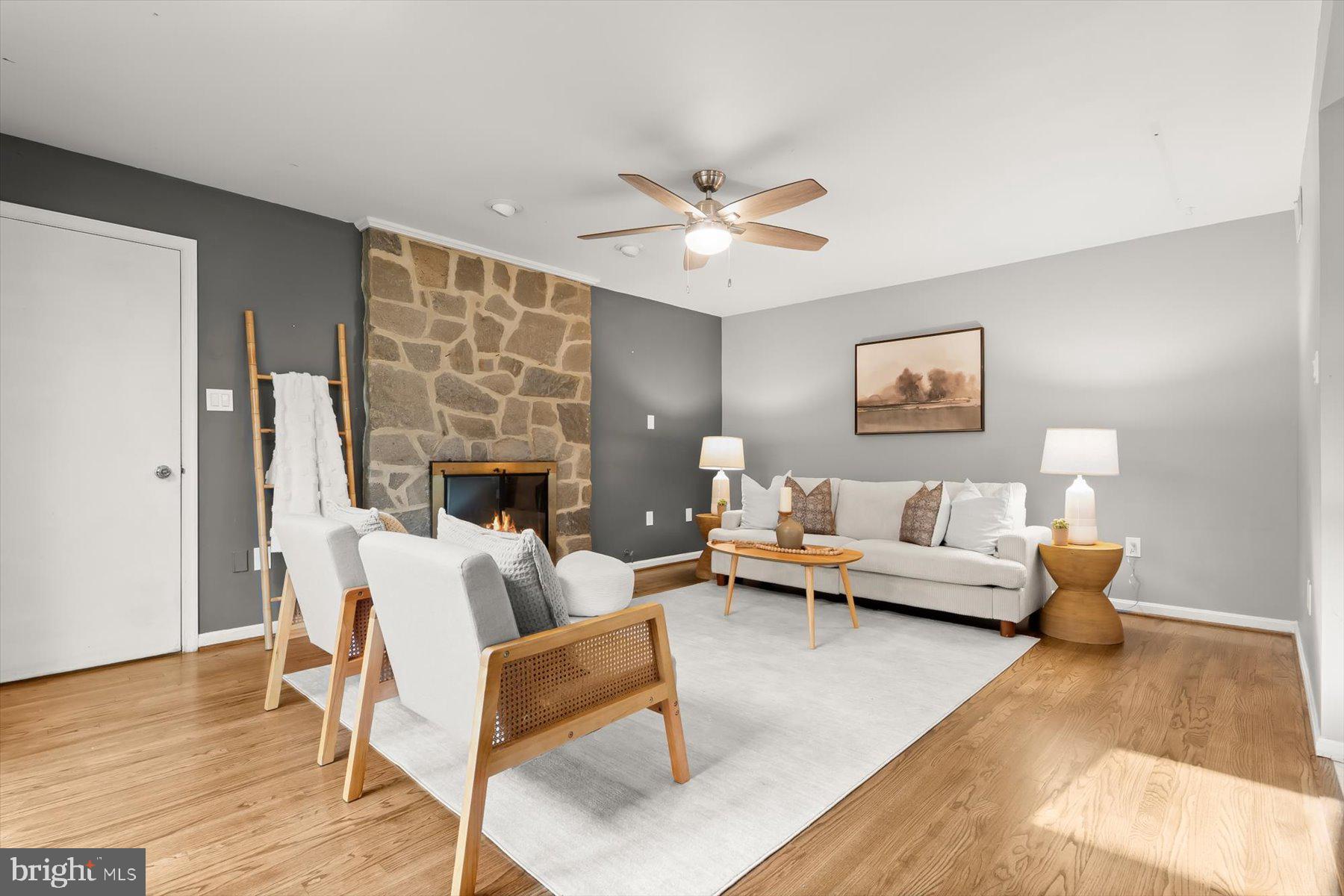 9600 Watkins Road Gaithersburg, MD 20882 - Photo 16 of 48 a living room with furniture a fireplace and a table