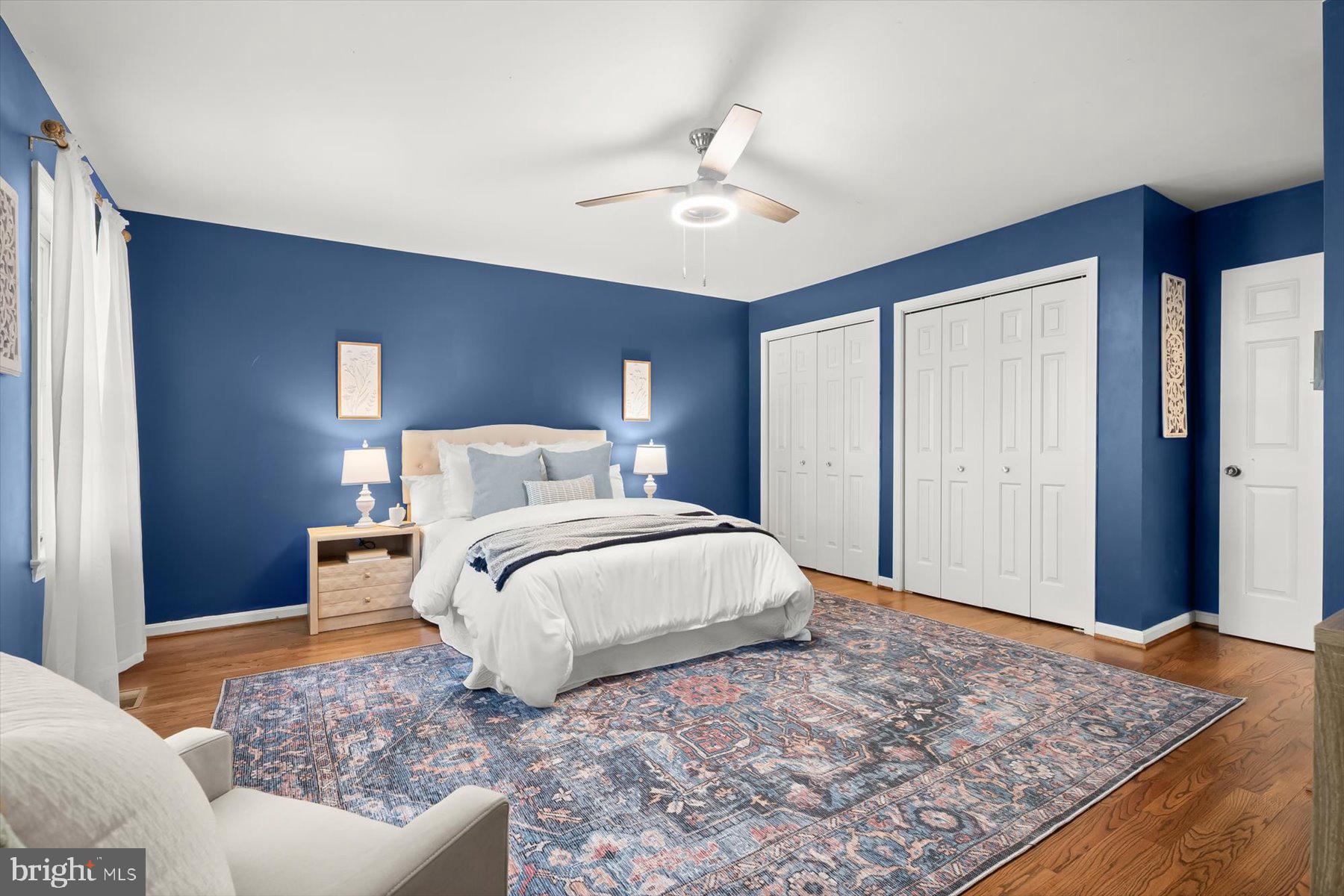 9600 Watkins Road Gaithersburg, MD 20882 - Photo 27 of 48 a bedroom with a large bed and a chandelier