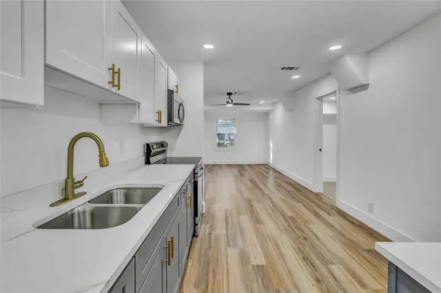 a kitchen with sink and refrigerator