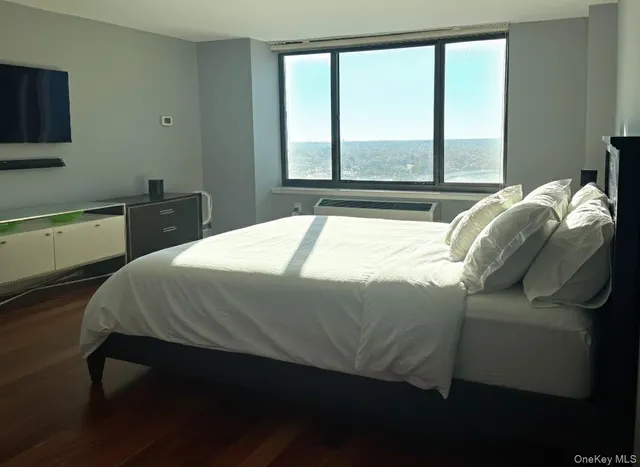 a bedroom with a bed and a window