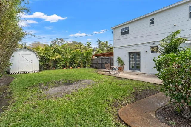 a view of a house with backyard and sitting area