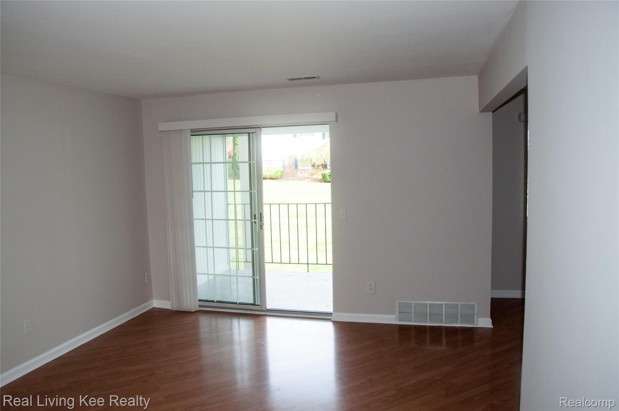 460 Baldwin Avenue, Unit 42 Rochester, MI 48307 - Photo 8 of 20 Living Room looking out the Doorwall facing East.jpg