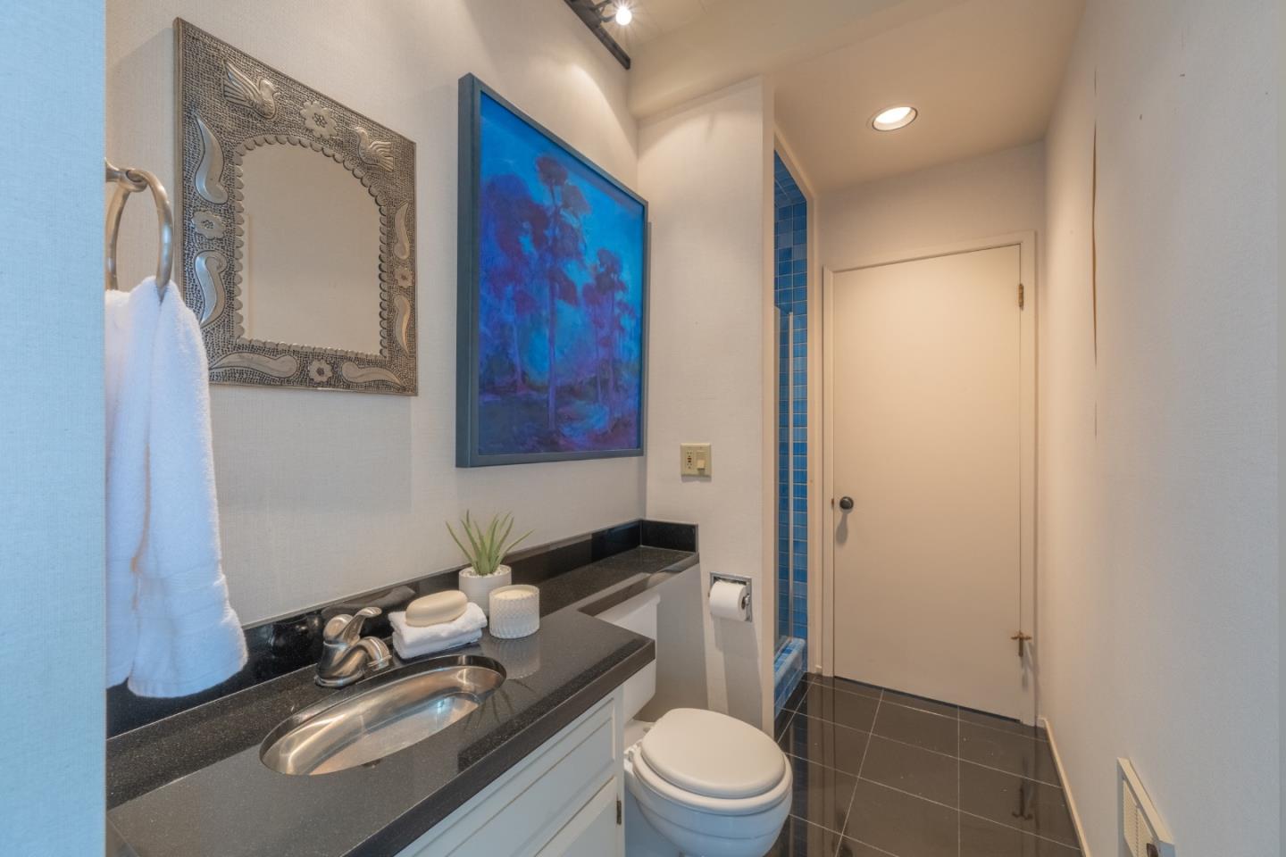 46 Middle Canyon Road Carmel Valley, CA 93924 - Photo 12 of 74 a bathroom with a granite countertop sink mirror vanity and toilet