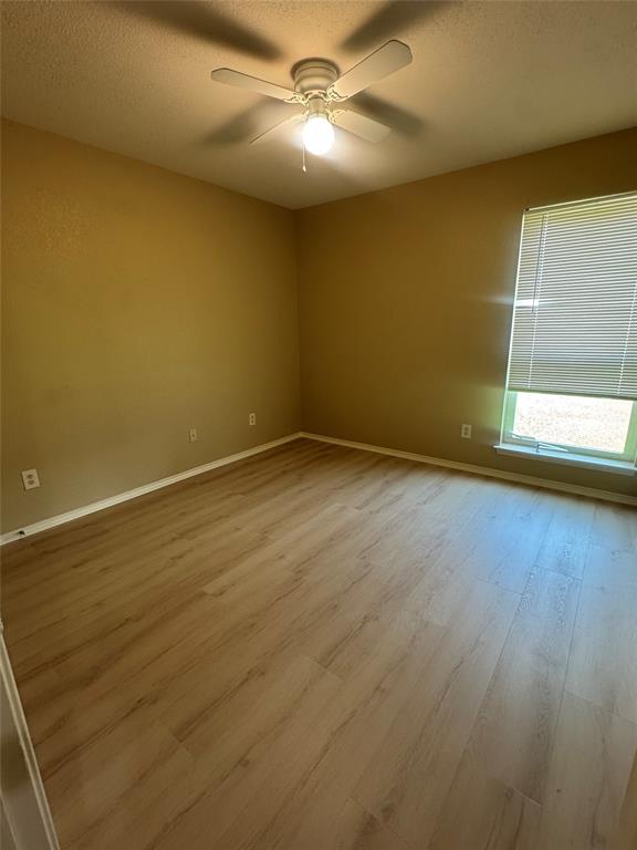 908 Cedar Ridge Lane Burleson, TX 76028 - Photo 18 of 24 a view of empty room with wooden floor and fan