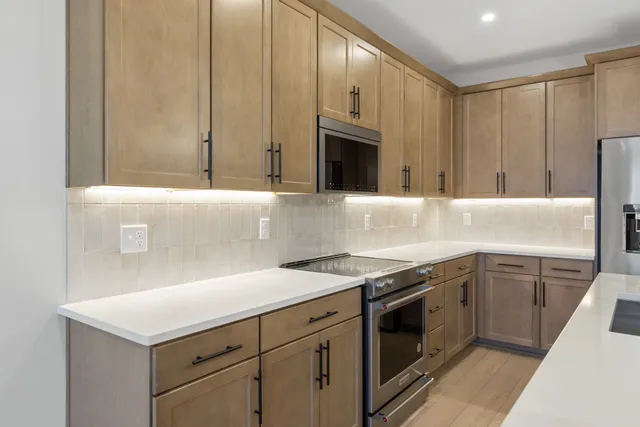 a kitchen with stainless steel appliances granite countertop a sink and a stove