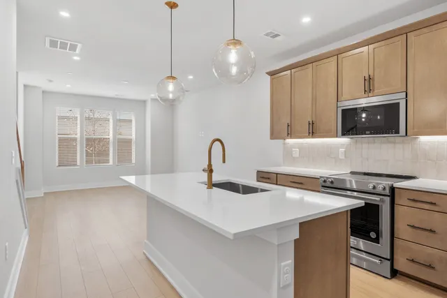 a kitchen with a sink a stove and cabinets