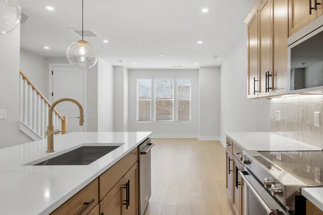 a kitchen with kitchen island a sink appliances and a counter top space