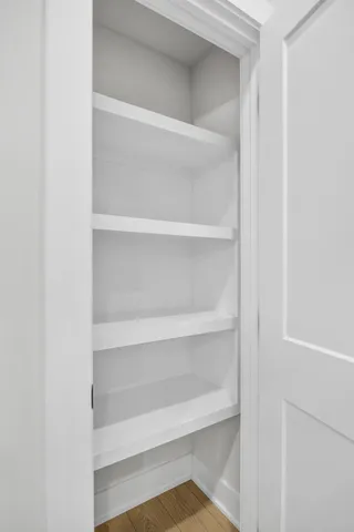 a view of walk in closet with empty racks