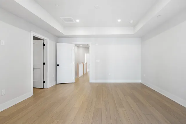 a view of an empty room with wooden floor