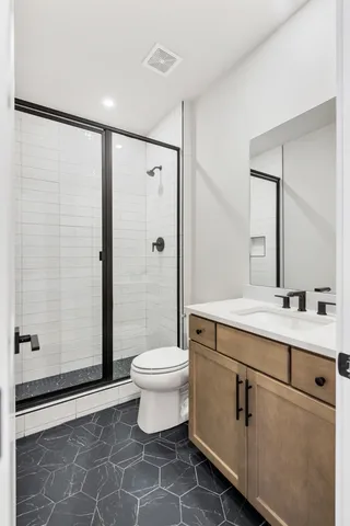 a bathroom with a sink mirror toilet and shower