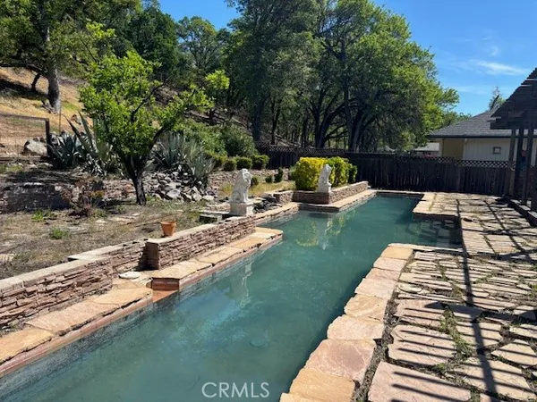 a view of a backyard with sitting area