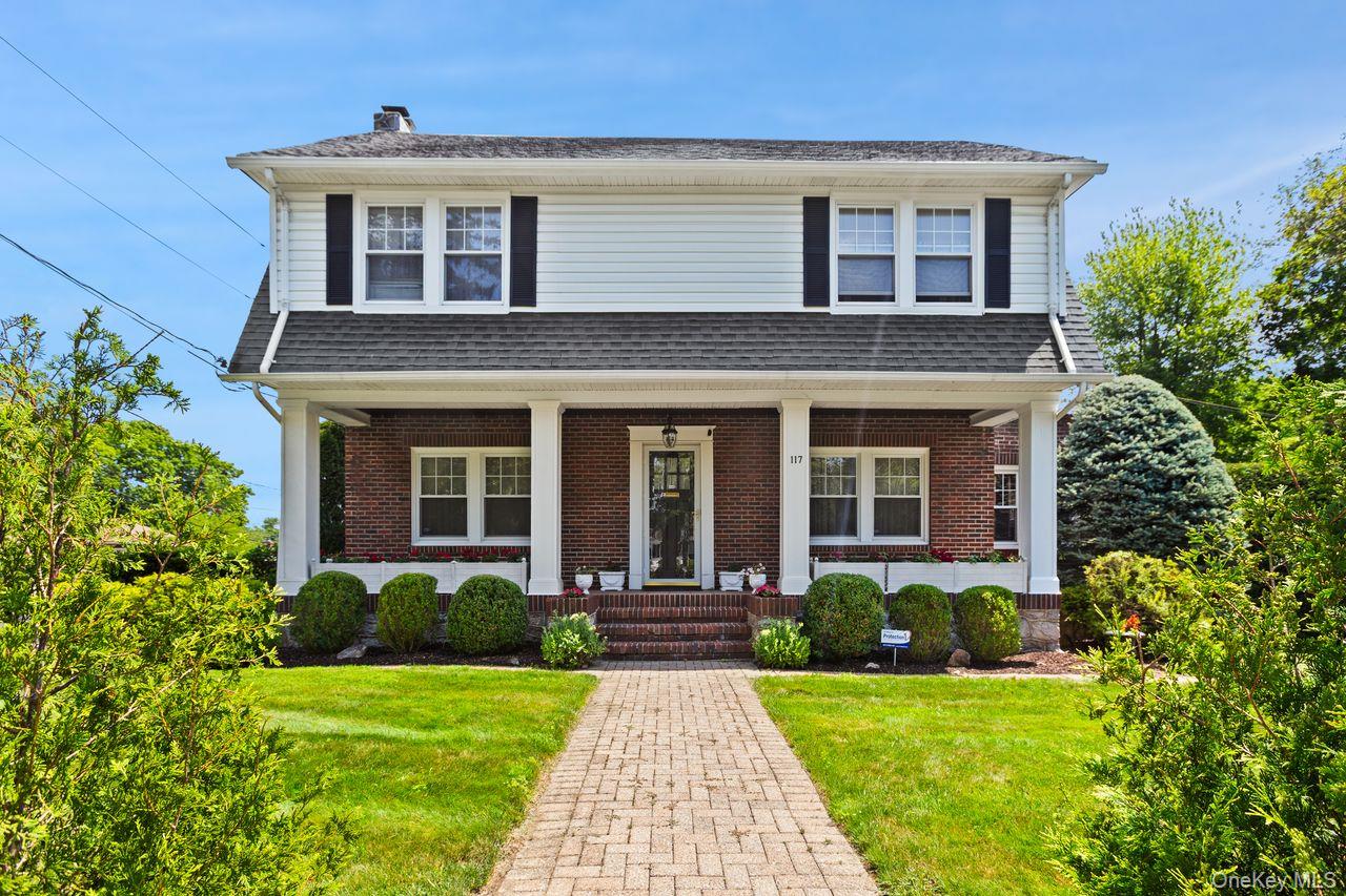 117 Perth Avenue New Rochelle, NY 10804 - Photo 1 of 1 View of front of house featuring covered porch, a chimney, a front lawn, brick siding, and roof with shingles