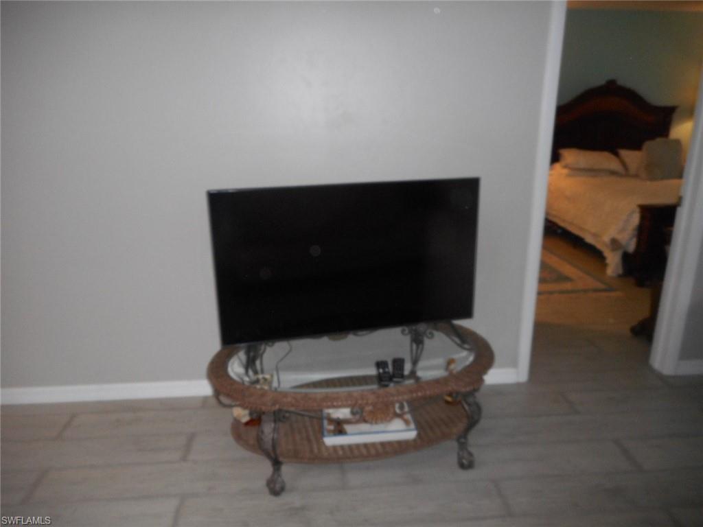 1007 Pine Isle Lane, Unit 1007 Naples, FL 34112 - Photo 16 of 22 a living room with furniture and a couch
