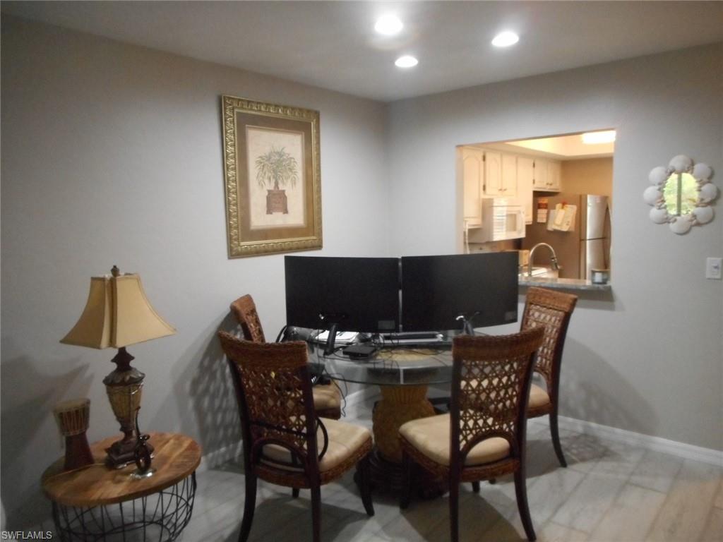 1007 Pine Isle Lane, Unit 1007 Naples, FL 34112 - Photo 19 of 22 a living room with furniture and a window