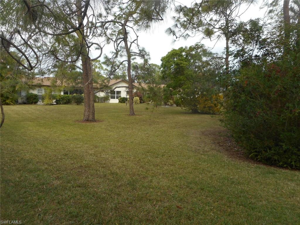 1007 Pine Isle Lane, Unit 1007 Naples, FL 34112 - Photo 21 of 22 a view of a field with trees in the background