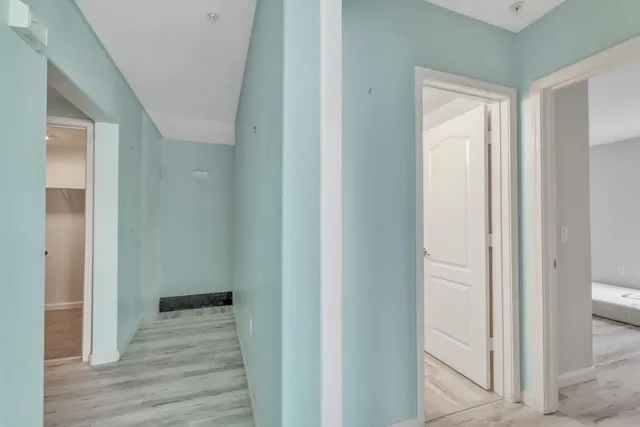 a view of a hallway with wooden floor