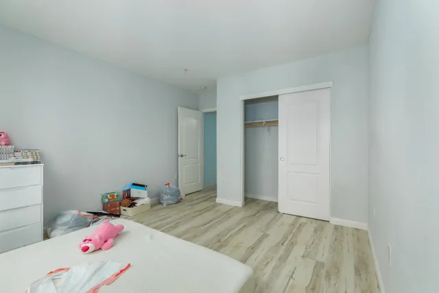 a bedroom with a bed and cabinets