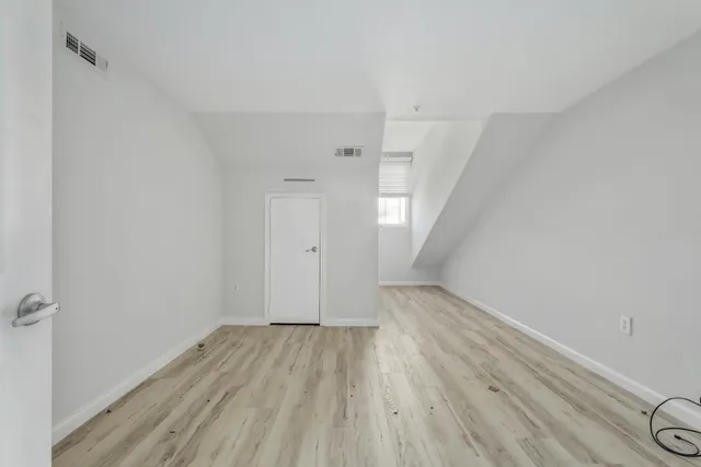 a view of wooden floor and windows in a room
