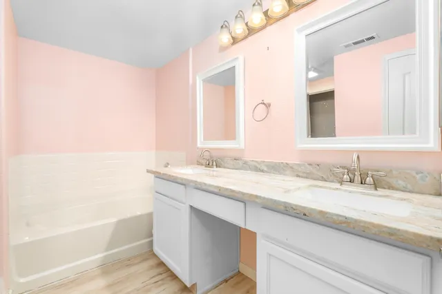 a bathroom with a granite countertop sink mirror and a
