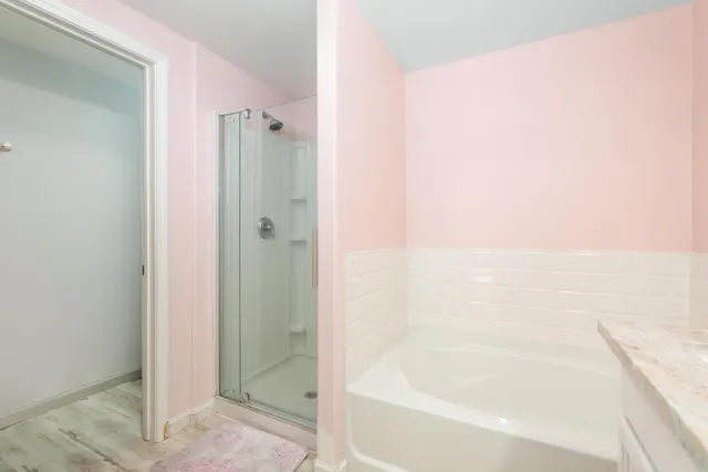 a bathroom with a bathtub and shower