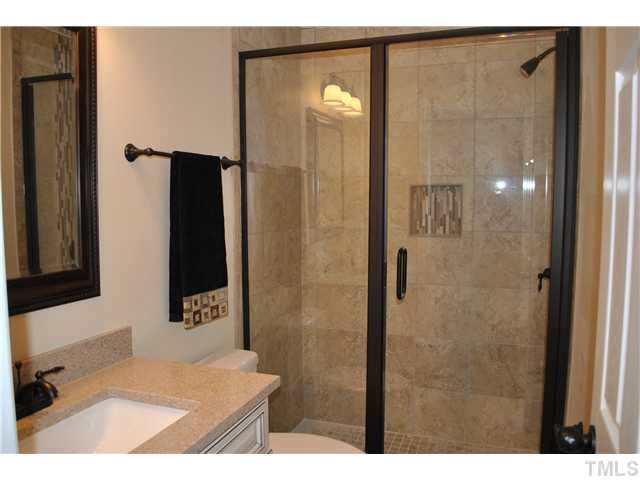 1205 Norris Street Raleigh, NC 27604 - Photo 7 of 23 Brand new master suite bath! Custom shower with glass tile! New vanity, new custom top and fixture. Ceramic tile floor and bronze hardware!