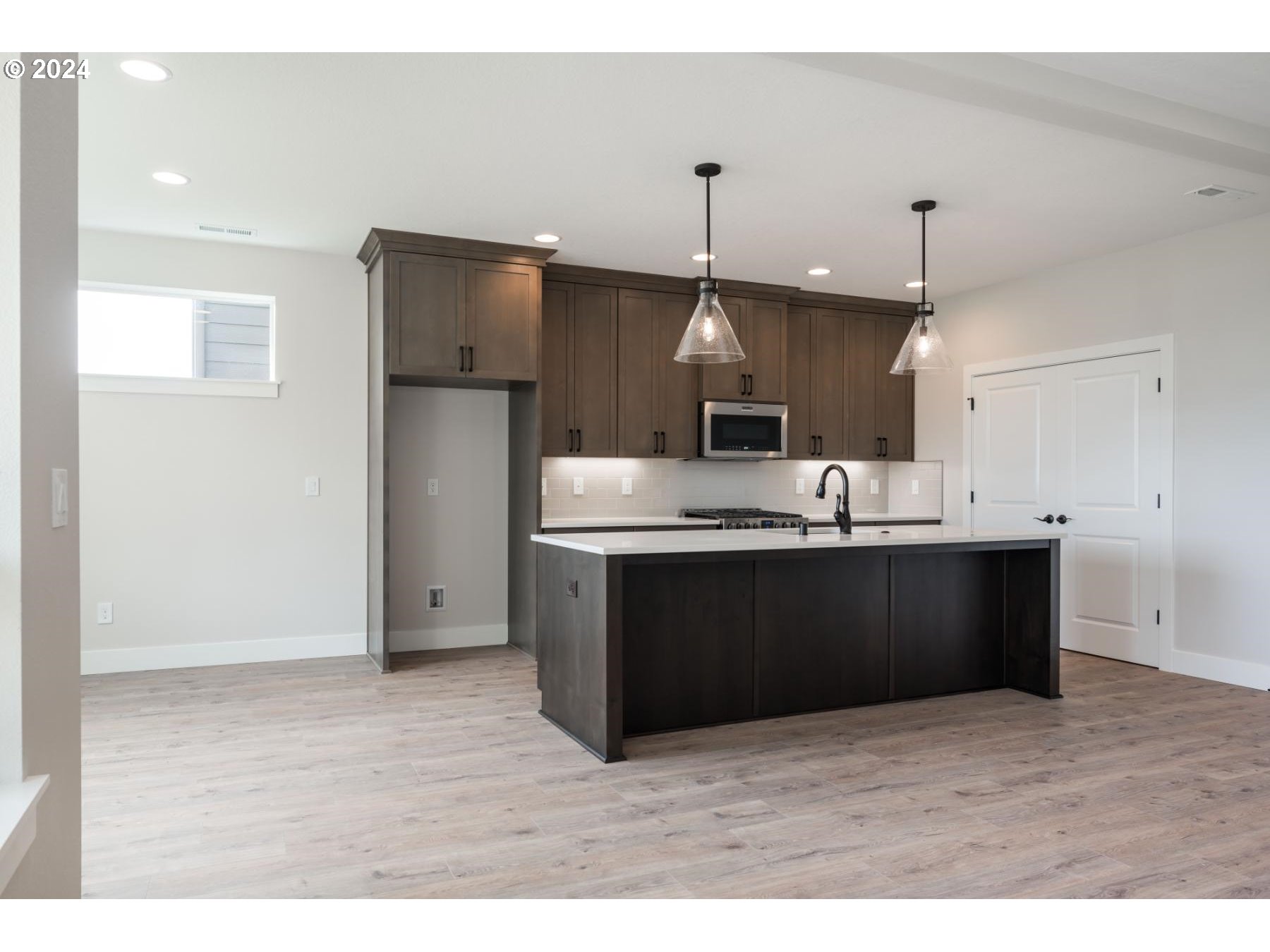 705 Northeast 174th Street Ridgefield, WA 98642 - Photo 7 of 13 a kitchen with stainless steel appliances kitchen island sink refrigerator and cabinets