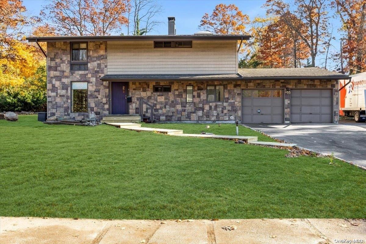 a front view of a house with a garden