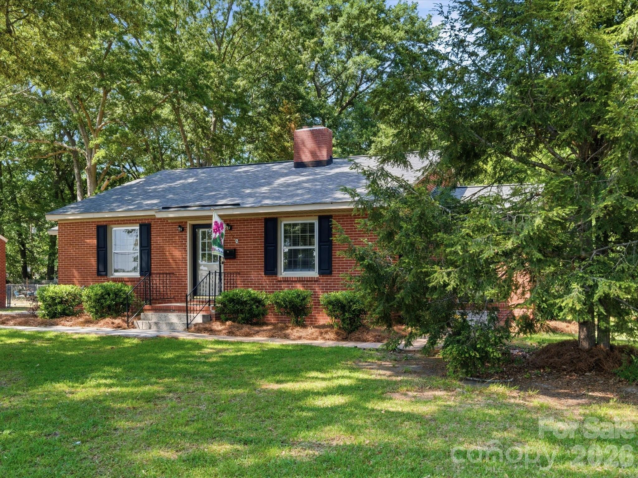 419 Knox Street Clover, SC 29710 - Photo 2 of 48 a front view of a house with a garden and plants