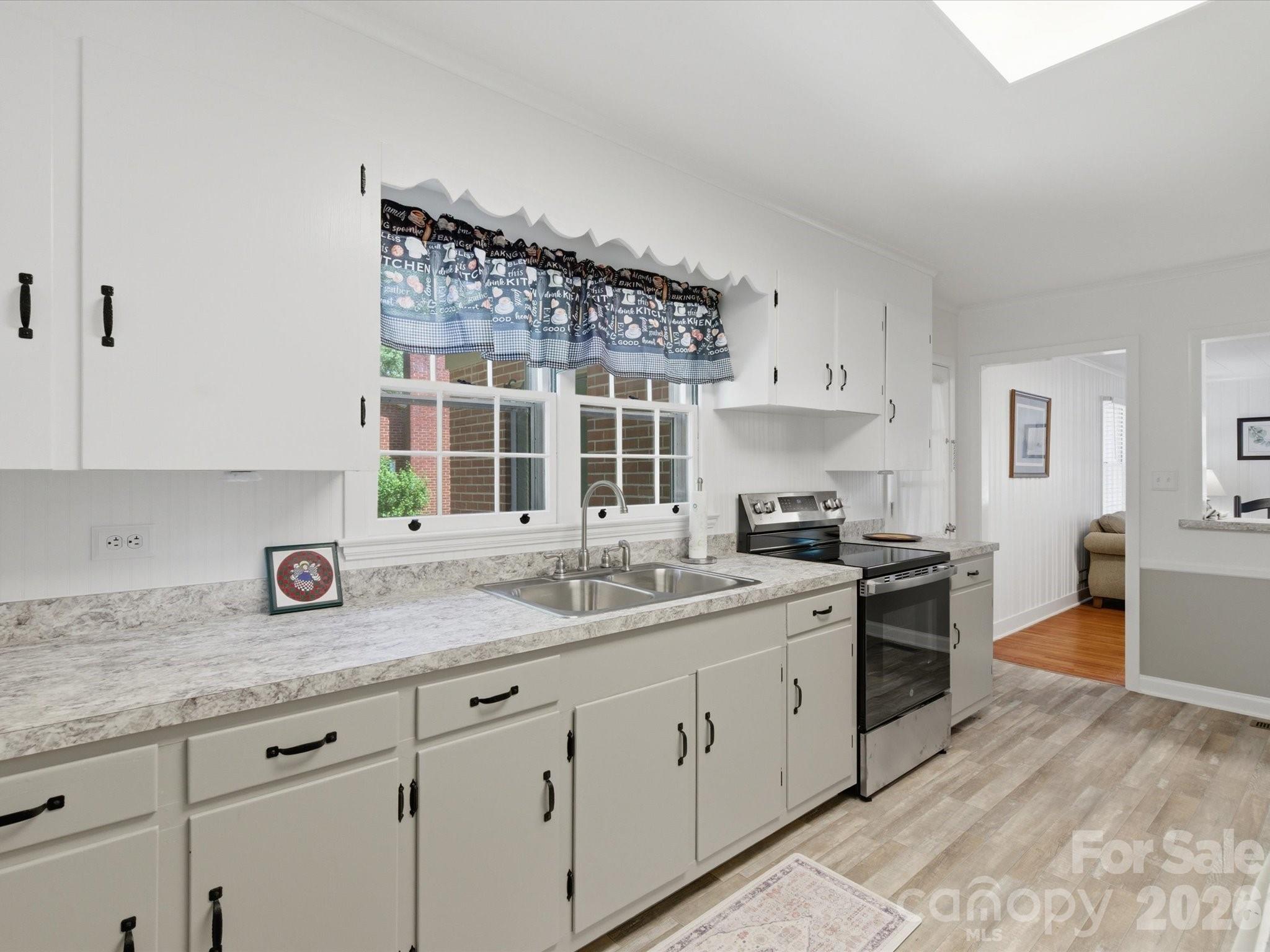 419 Knox Street Clover, SC 29710 - Photo 22 of 48 a kitchen with a sink stove and cabinets
