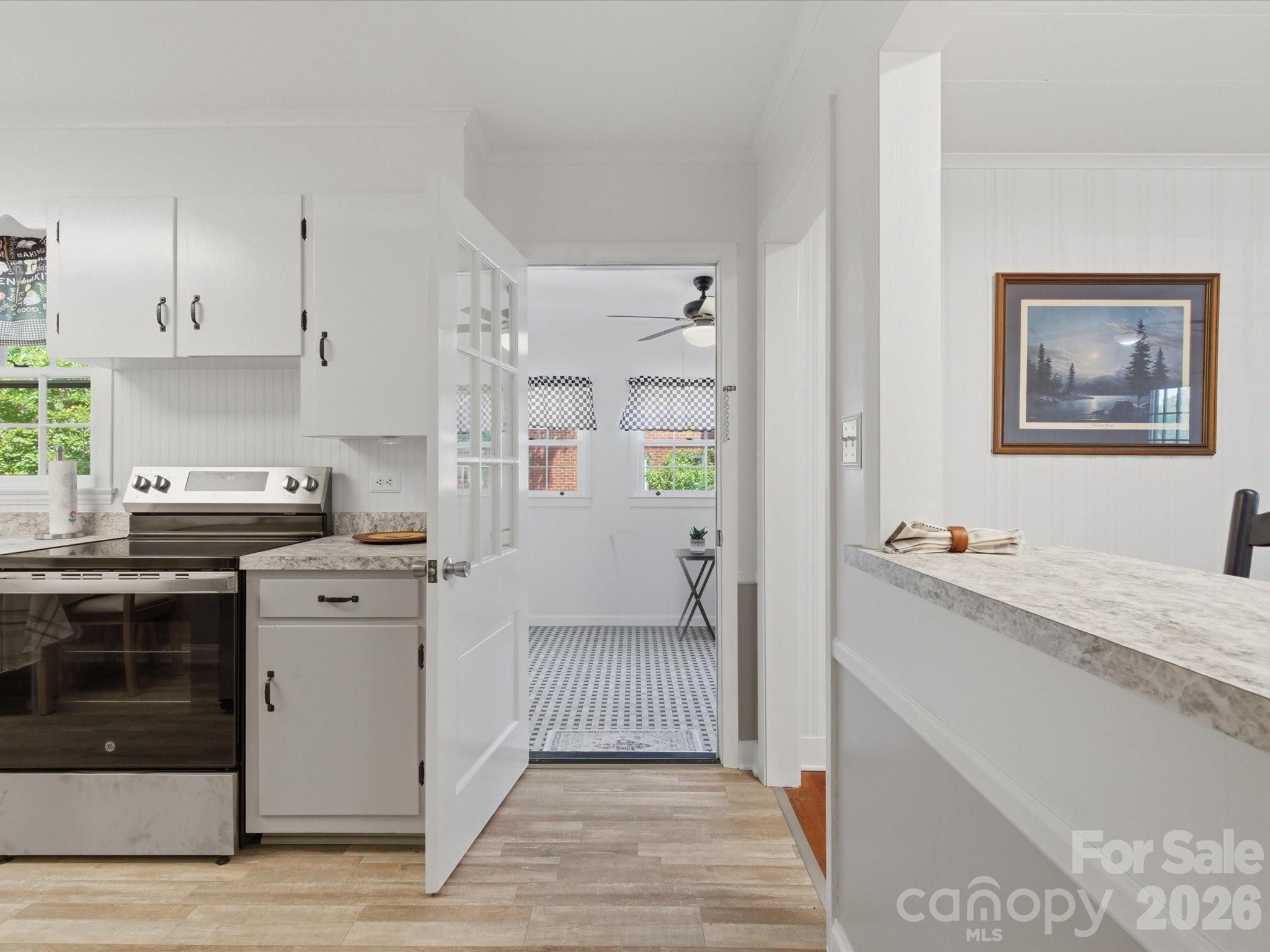 419 Knox Street Clover, SC 29710 - Photo 25 of 48 a kitchen with a stove and white cabinets