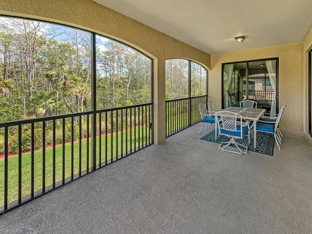 a view of a two room with furniture and floor to ceiling window