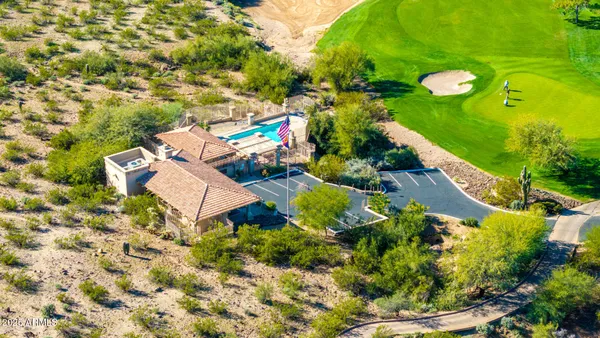 an aerial view of a house with a yard and lake view