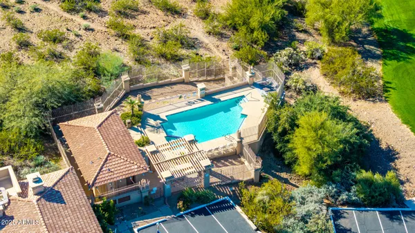 an aerial view of a house with a yard and swimming pool