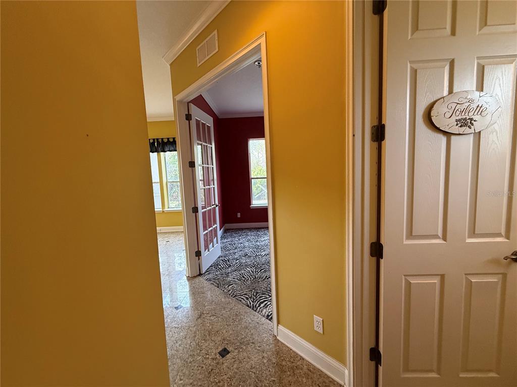 800 North End Street St. Augustine, FL 32095 - Photo 15 of 52 a view of a hallway with wooden floor and a bathroom