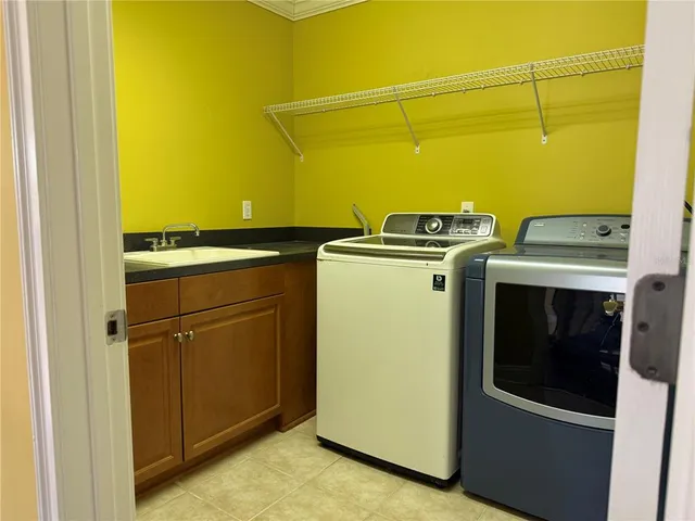 a view of a livingroom with wooden floor and a ceiling fan