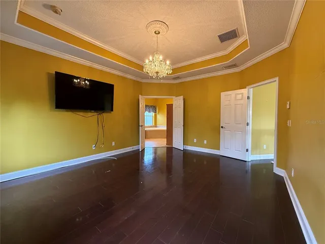 a view of a livingroom with wooden floor and a flat screen tv