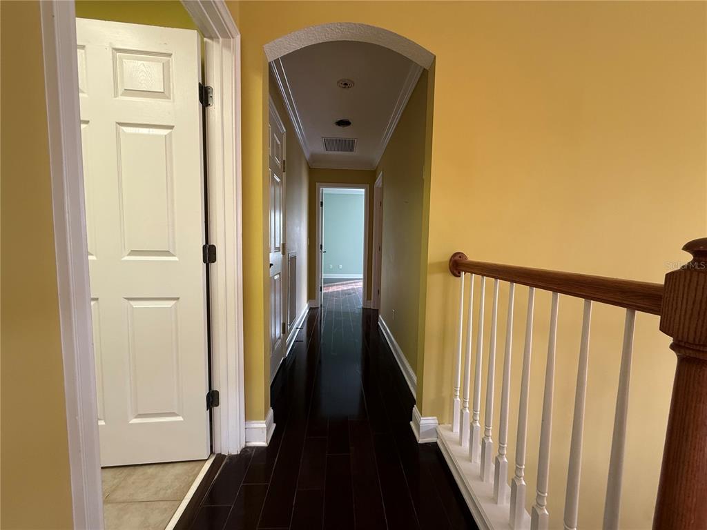 800 North End Street St. Augustine, FL 32095 - Photo 37 of 52 a view of a hallway with wooden floor and staircase