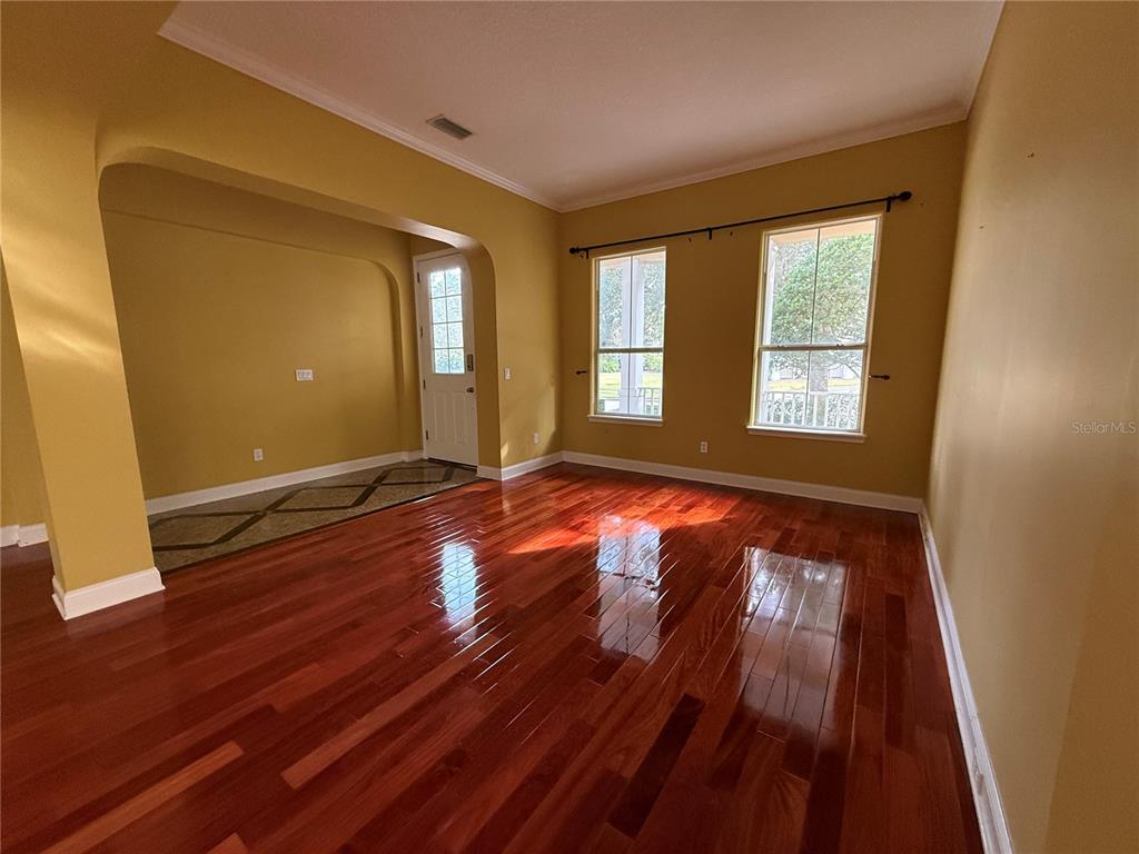 800 North End Street St. Augustine, FL 32095 - Photo 7 of 52 a view of an empty room with wooden floor and a window