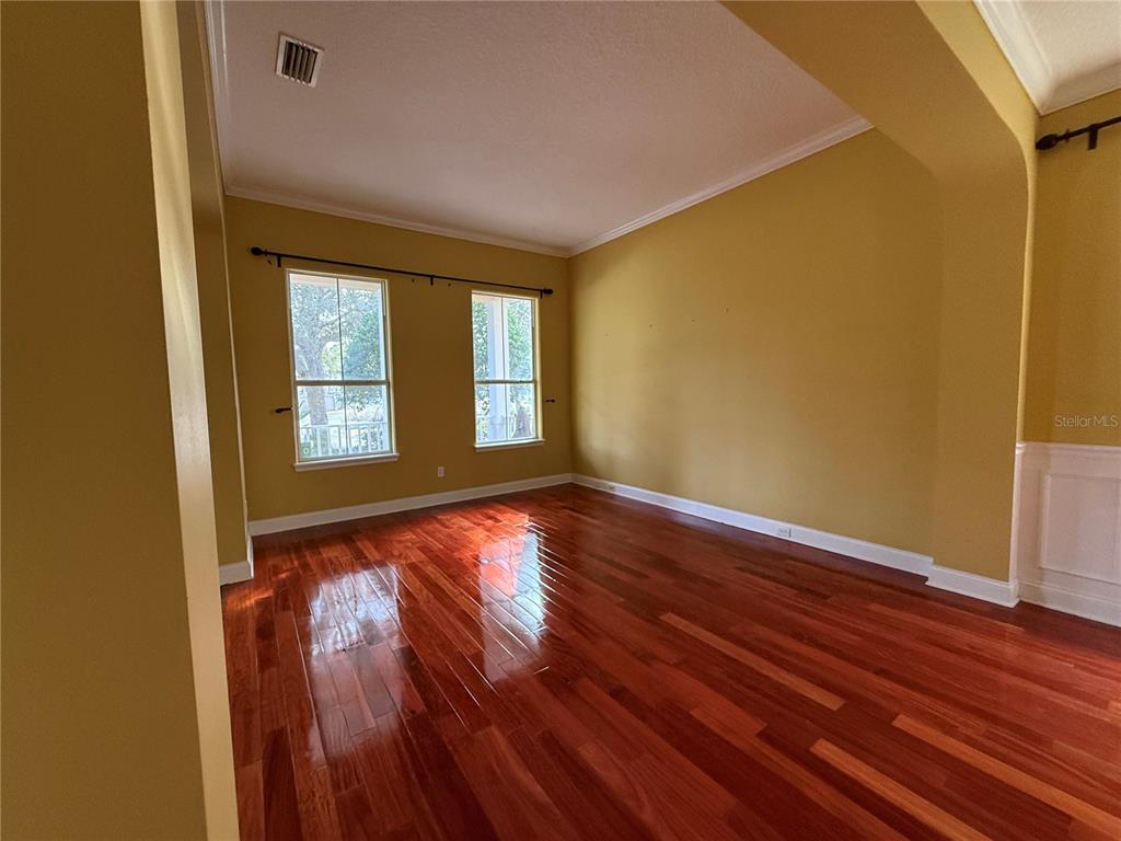 800 North End Street St. Augustine, FL 32095 - Photo 8 of 52 a view of an empty room with wooden floor and a window