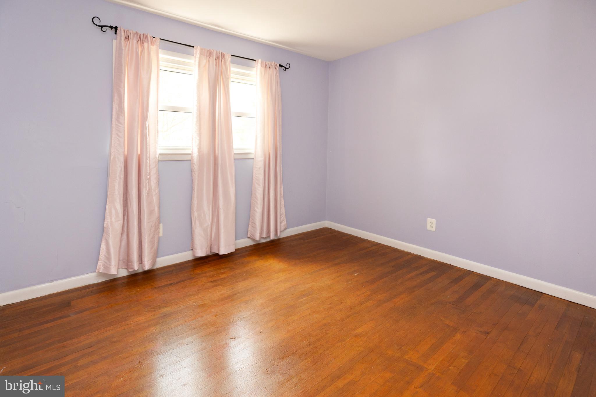 503 Pasadena Drive Magnolia, NJ 08049 - Photo 17 of 43 an empty room with wooden floor and windows