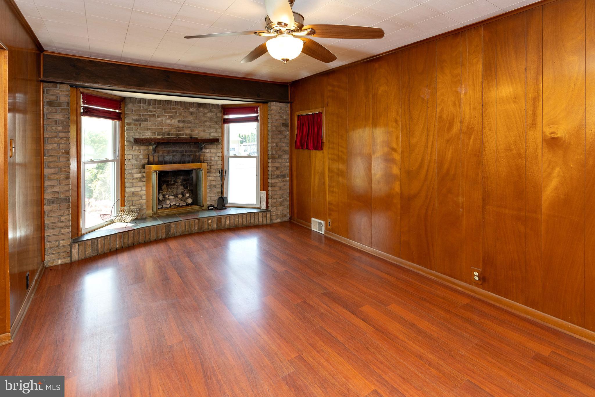 503 Pasadena Drive Magnolia, NJ 08049 - Photo 26 of 43 wooden floor in an empty room with a fireplace
