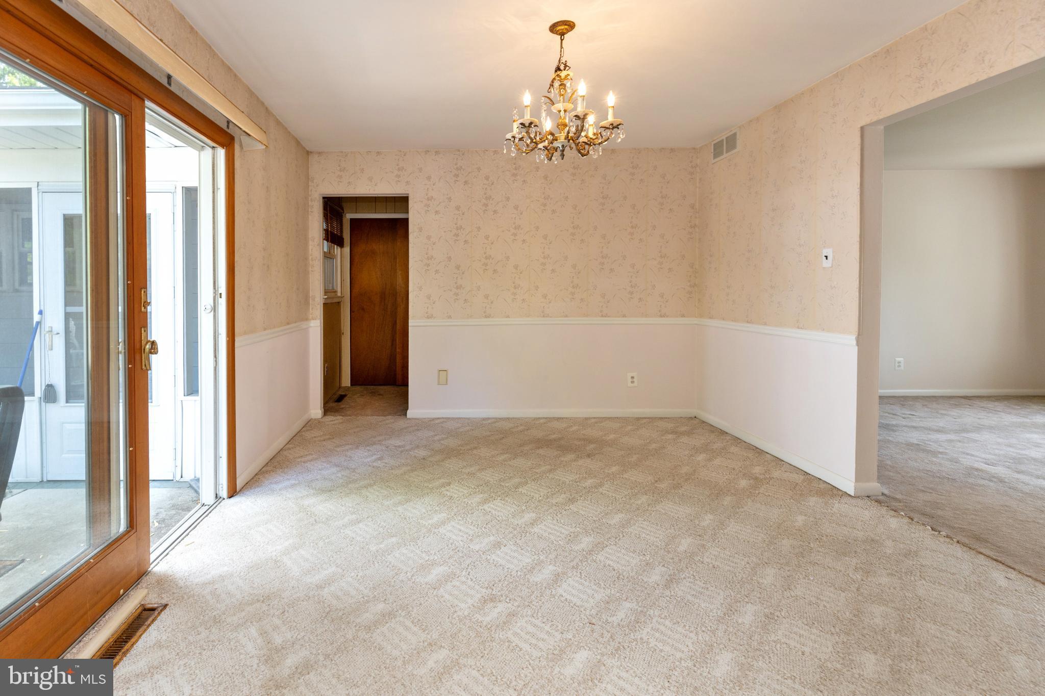 503 Pasadena Drive Magnolia, NJ 08049 - Photo 10 of 43 en empty room with windows and chandelier