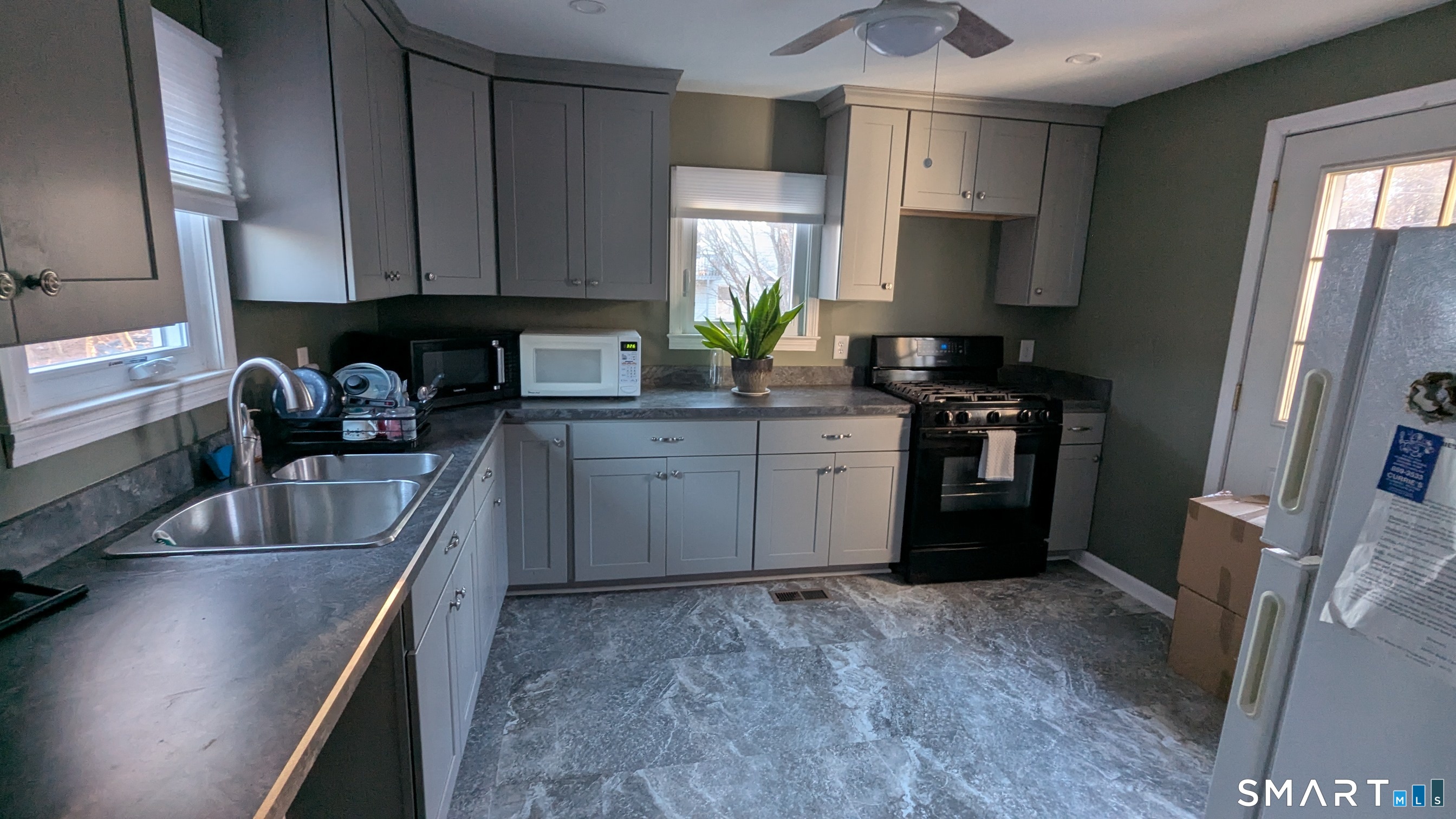 20 Geer Avenue Norwich, CT 06360 - Photo 2 of 10 a kitchen with stainless steel appliances granite countertop a sink stove and refrigerator
