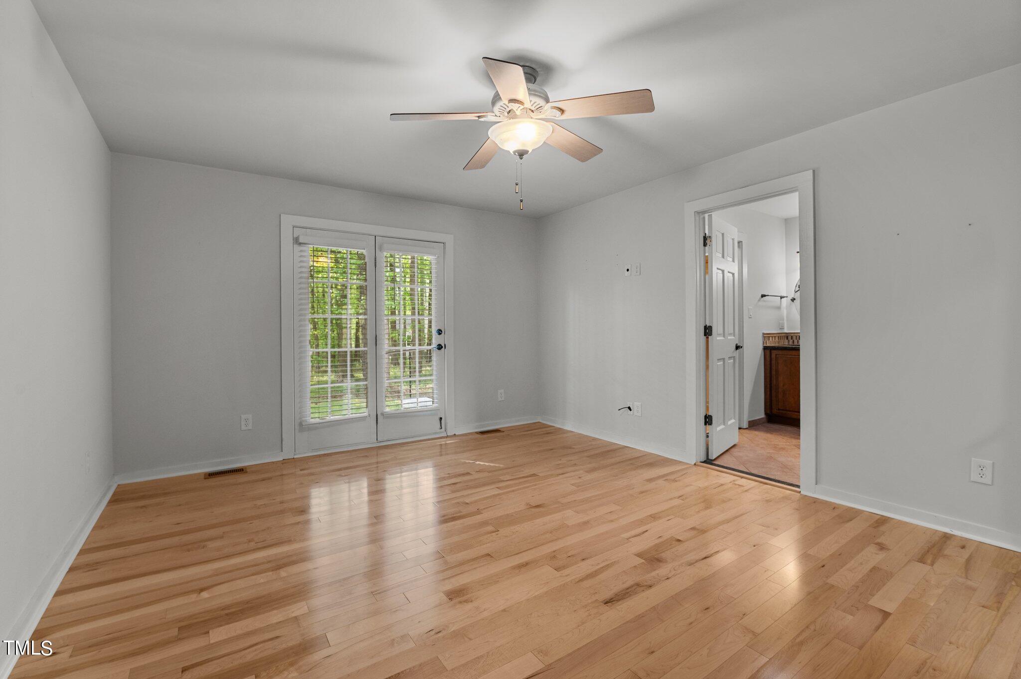 1901 Nipper Road Raleigh, NC 27614 - Photo 24 of 57 a view of an empty room with wooden floor and a window