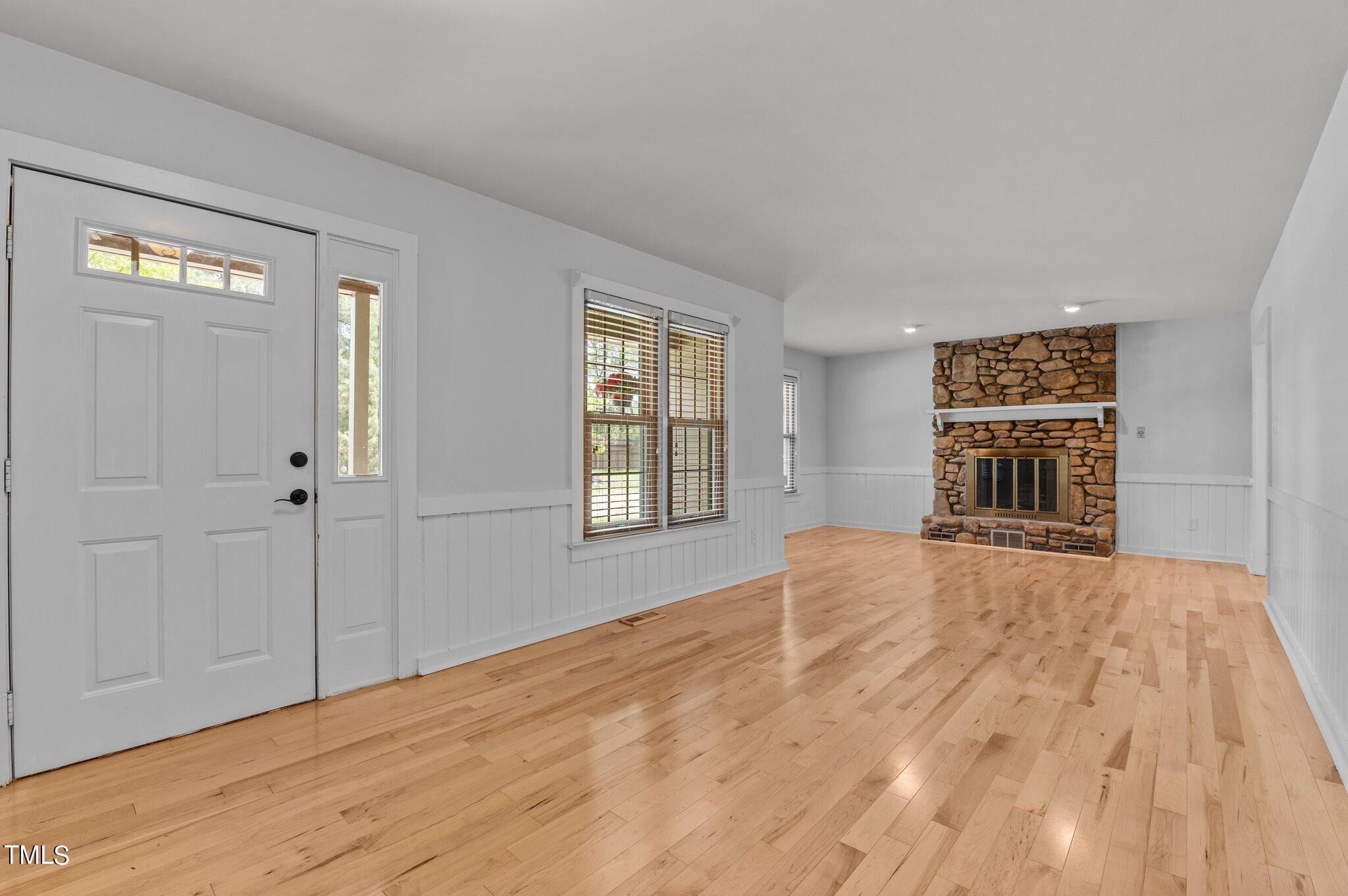 1901 Nipper Road Raleigh, NC 27614 - Photo 7 of 57 a view of an empty room with wooden floor and windows