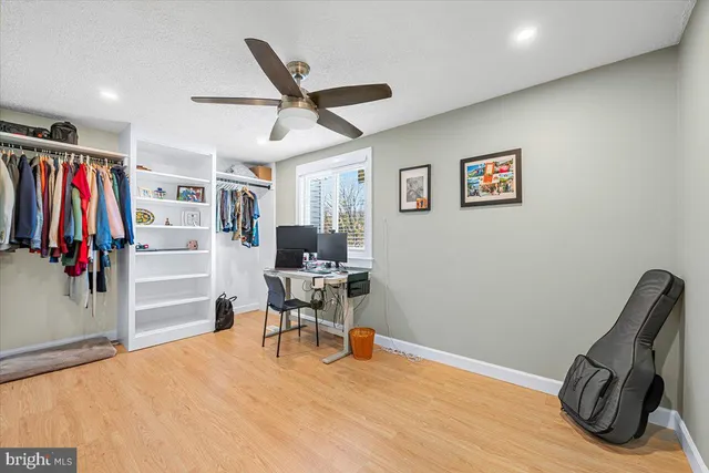 a view of a workspace with furniture and closet