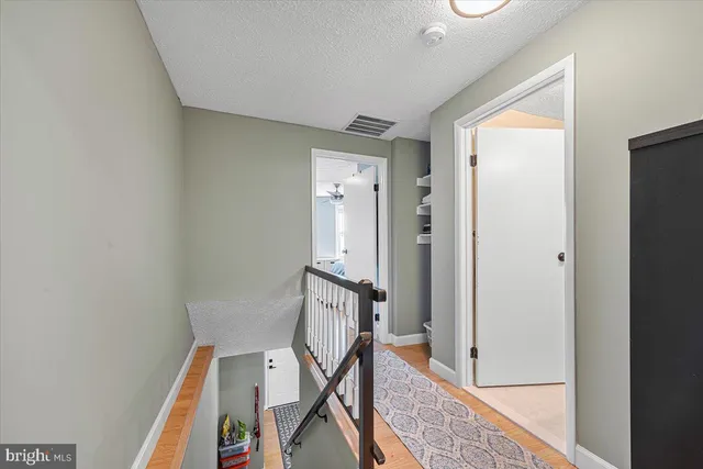 a bathroom with a sink a toilet a mirror a bathtub and shower